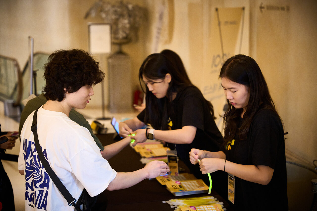 Attendee receiving an edeXa Punch-In Campaign wristband at the registration desk