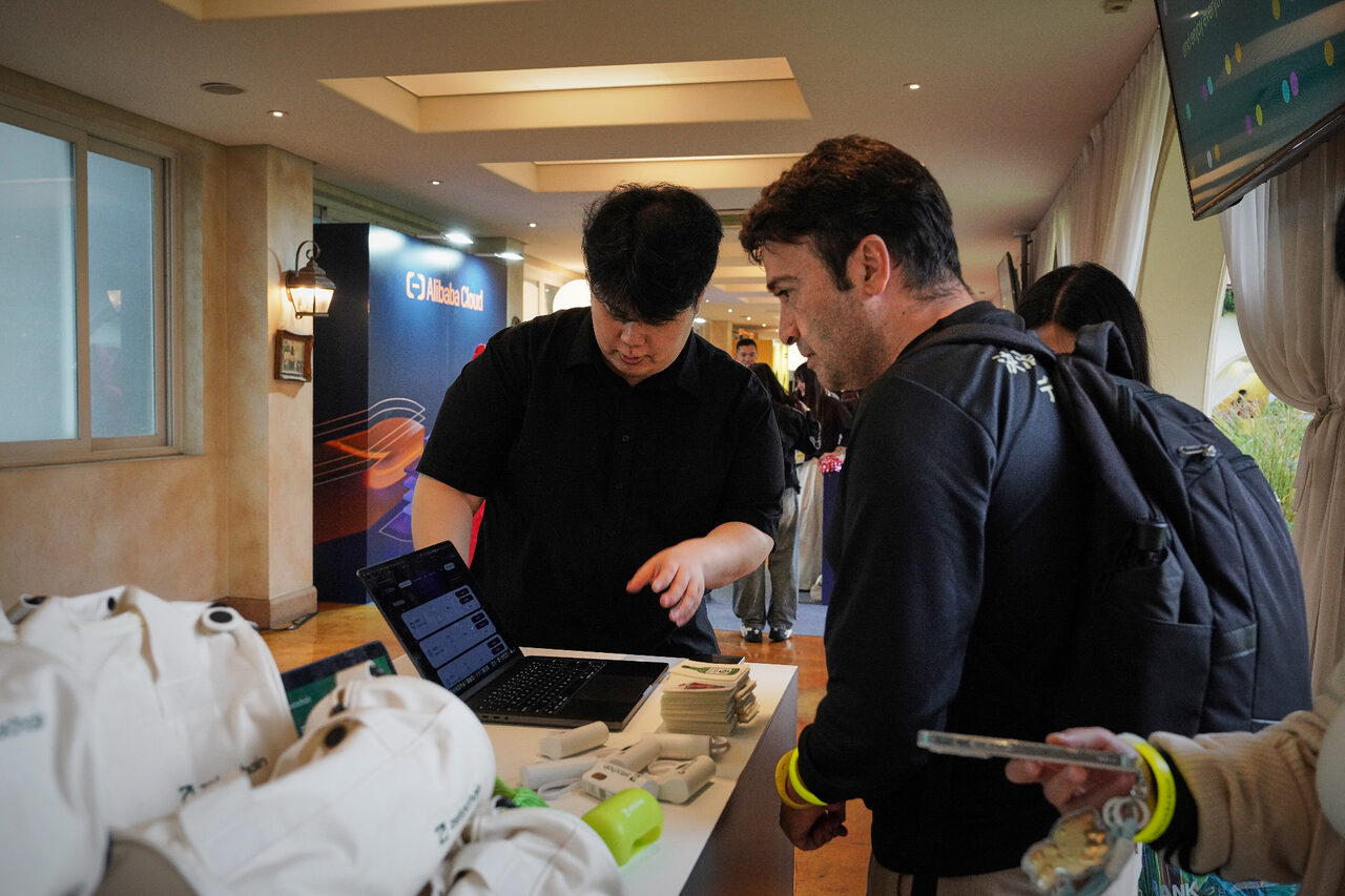 edeXa event demo table with attendees reviewing the product on a laptop